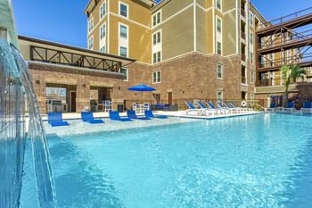 Resort-style pool with in-pool tanning shelf